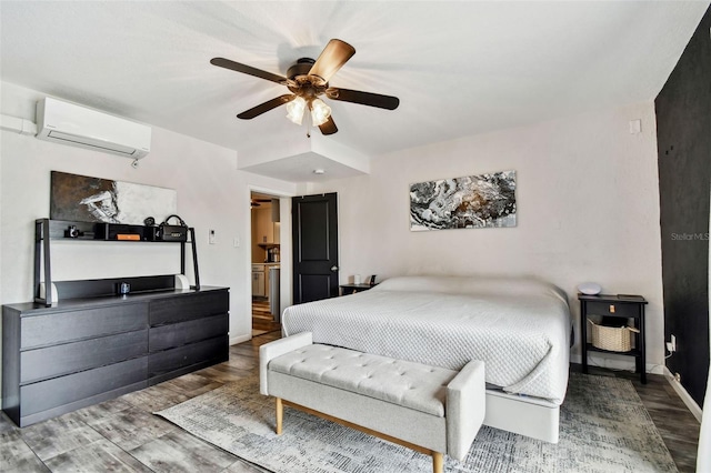 bedroom featuring a wall mounted AC and ceiling fan