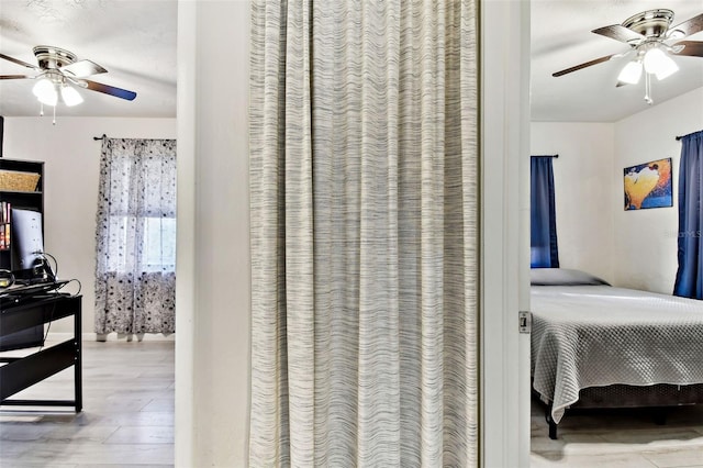 bedroom featuring wood-type flooring and ceiling fan