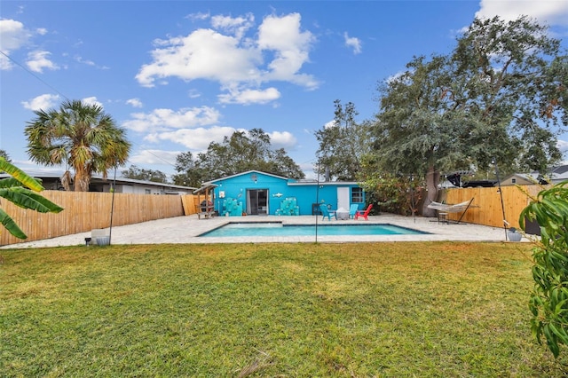 rear view of house featuring a patio area and a yard