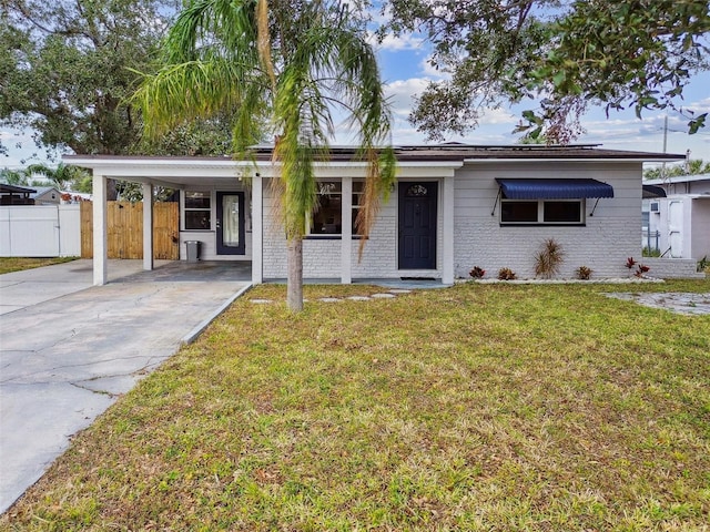 single story home featuring a carport and a front lawn