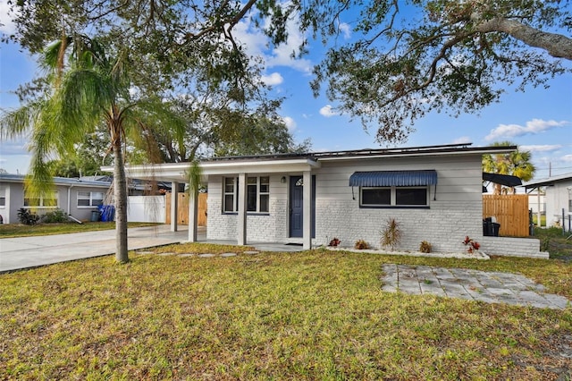 ranch-style house with a carport and a front lawn