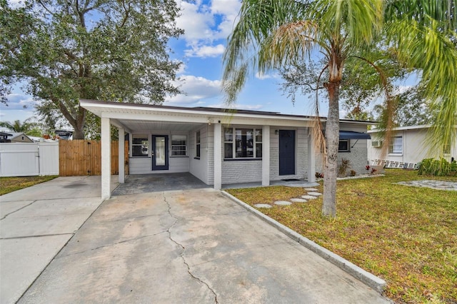 view of front of house with a carport and a front lawn