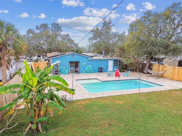 view of pool featuring a patio area, a fenced backyard, and a lawn