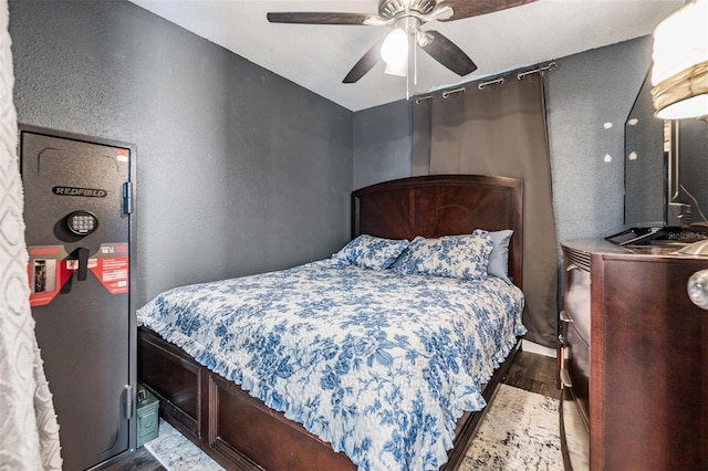 bedroom featuring ceiling fan and dark hardwood / wood-style floors