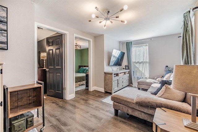 sitting room with hardwood / wood-style flooring and a notable chandelier