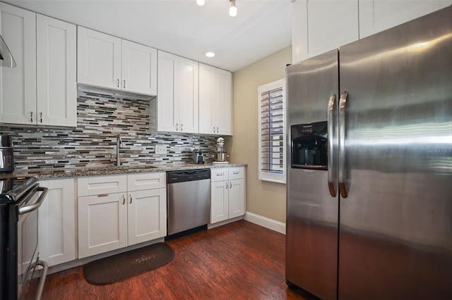 kitchen featuring sink, white cabinets, stone countertops, and appliances with stainless steel finishes