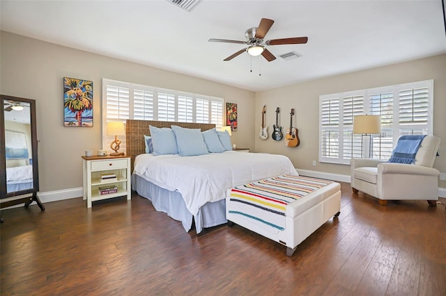 bedroom featuring ceiling fan, dark wood-type flooring, and multiple windows