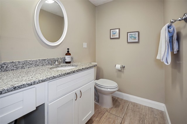 bathroom with toilet and vanity