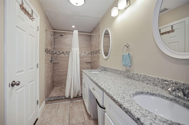 bathroom with curtained shower and vanity