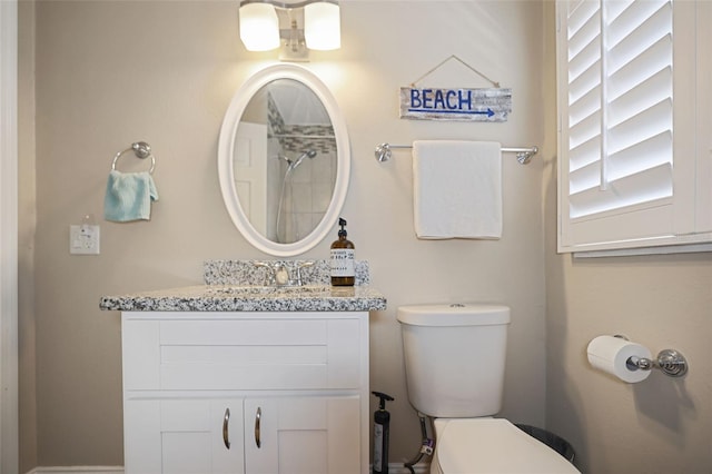 bathroom featuring toilet and vanity