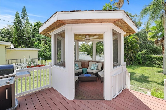 deck featuring a yard, area for grilling, and a sunroom