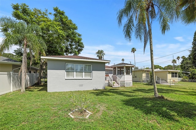 rear view of property with a yard