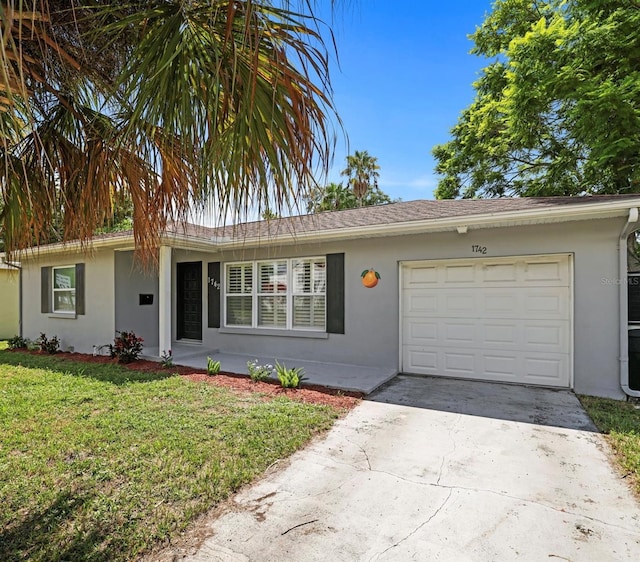 ranch-style house with a front yard and a garage