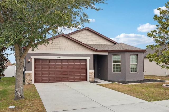 view of front of property with a front yard and a garage