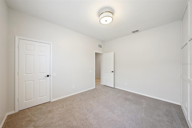 empty room featuring light colored carpet