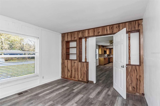 spare room featuring ceiling fan and dark wood-type flooring