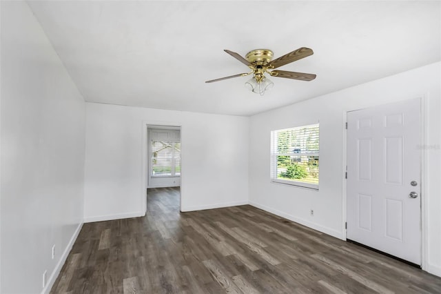 empty room with ceiling fan and dark wood-type flooring