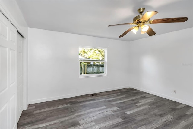 unfurnished room featuring ceiling fan and dark hardwood / wood-style floors