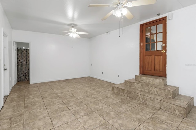 tiled empty room featuring ceiling fan