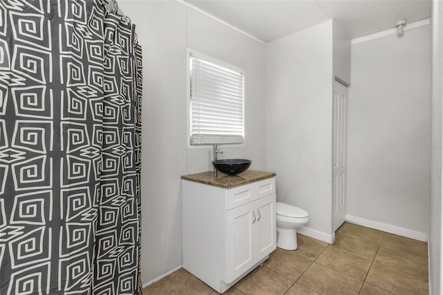 bathroom featuring toilet, tile patterned flooring, and vanity