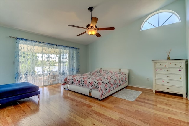 bedroom with ceiling fan, light hardwood / wood-style floors, multiple windows, and lofted ceiling