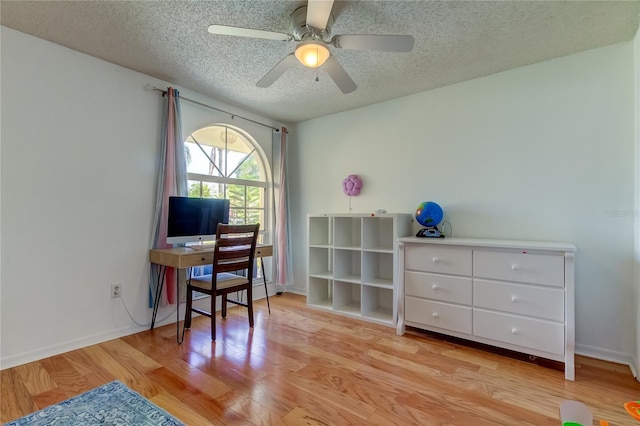 office area featuring ceiling fan, light hardwood / wood-style floors, and a textured ceiling