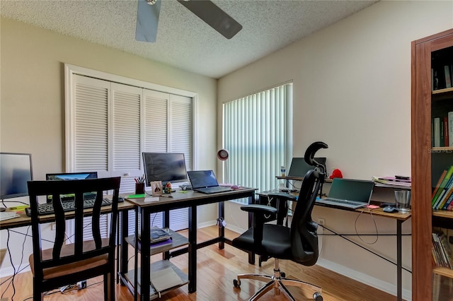 office with a textured ceiling, ceiling fan, and wood-type flooring