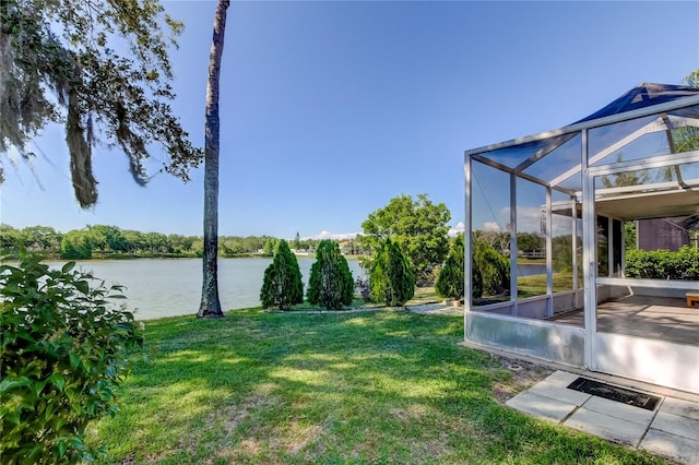 view of yard featuring a lanai and a water view