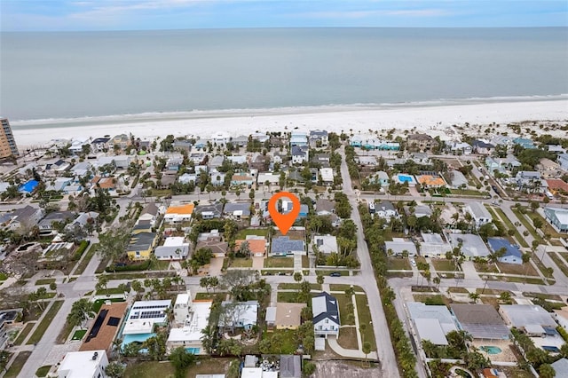 birds eye view of property featuring a water view and a beach view