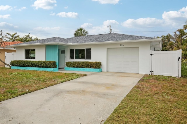 ranch-style home with a garage and a front lawn