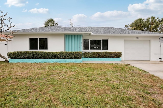 single story home featuring a garage and a front yard