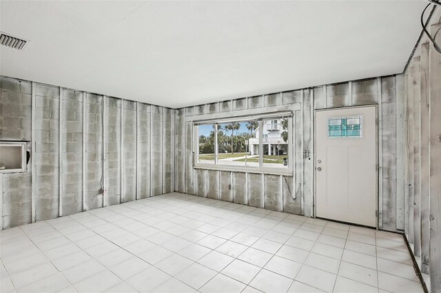 foyer entrance with light tile patterned floors