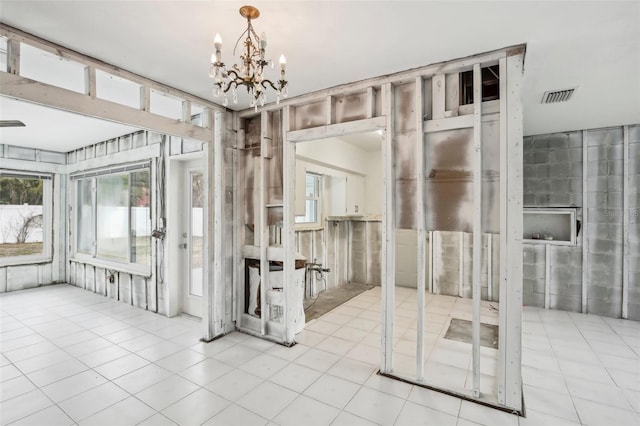 interior space with a chandelier and light tile patterned floors