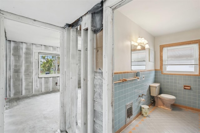 bathroom with toilet and tile patterned flooring