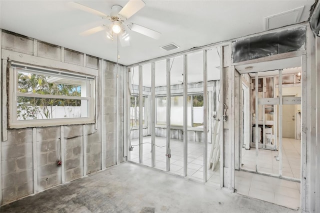 miscellaneous room featuring concrete floors and ceiling fan