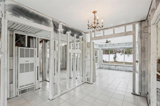 interior space with ceiling fan with notable chandelier