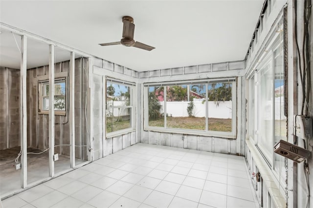 unfurnished sunroom featuring plenty of natural light and ceiling fan