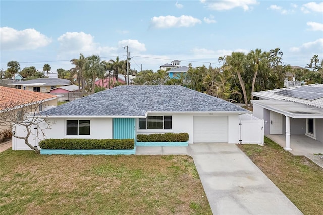 ranch-style home with a garage and a front lawn