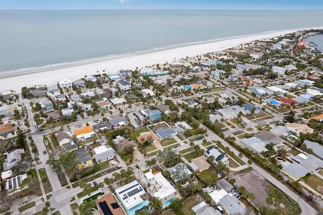 birds eye view of property featuring a beach view and a water view