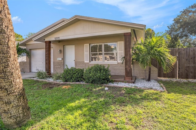 view of front facade featuring a front yard and a garage