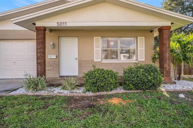 view of front of property with a porch and a garage