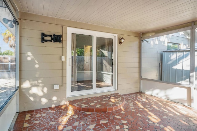 unfurnished sunroom featuring wood ceiling