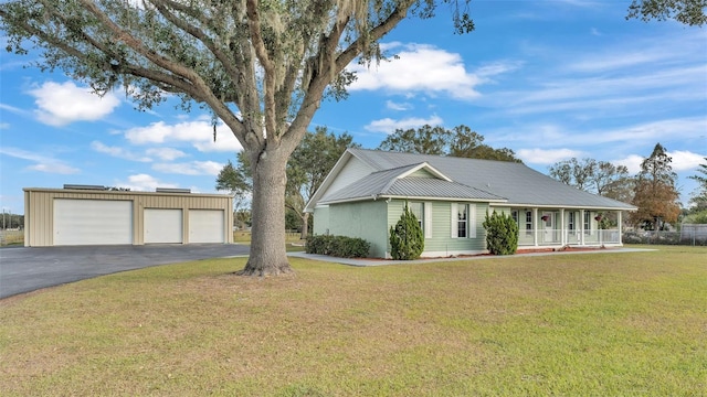 ranch-style home featuring a front yard, a garage, and covered porch