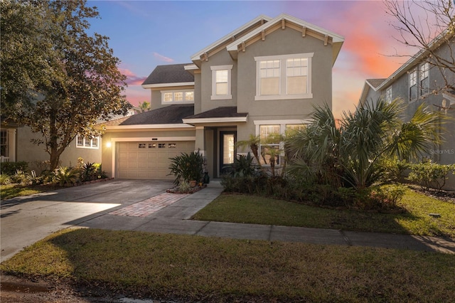 view of front facade featuring a garage and a yard