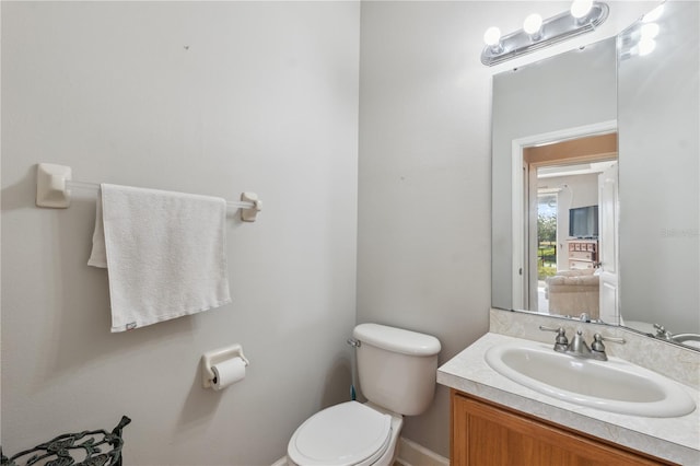 bathroom with toilet and vanity