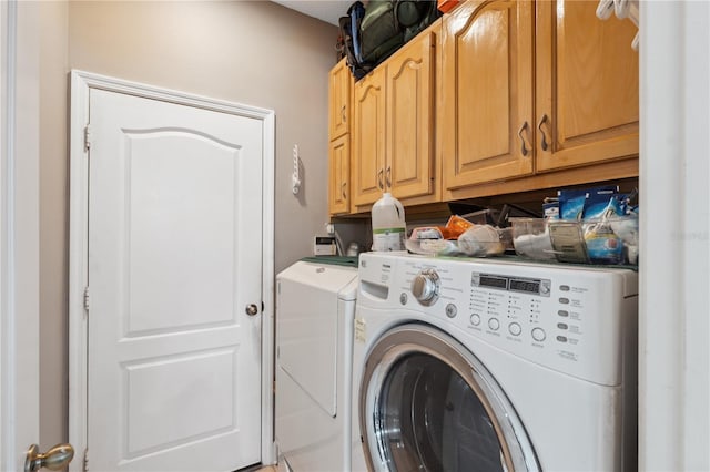 laundry area with cabinets and washing machine and dryer