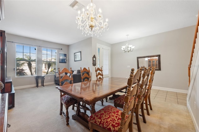 dining space featuring light colored carpet and a chandelier