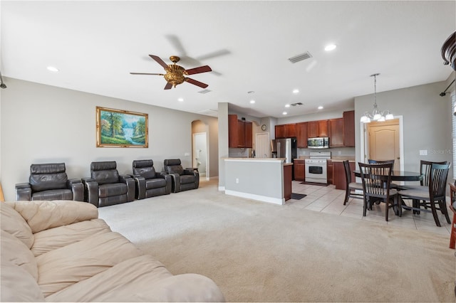 living room featuring ceiling fan with notable chandelier and light carpet