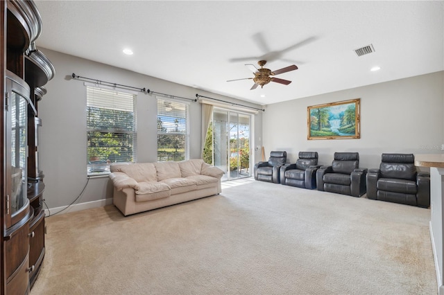 carpeted home theater with ceiling fan