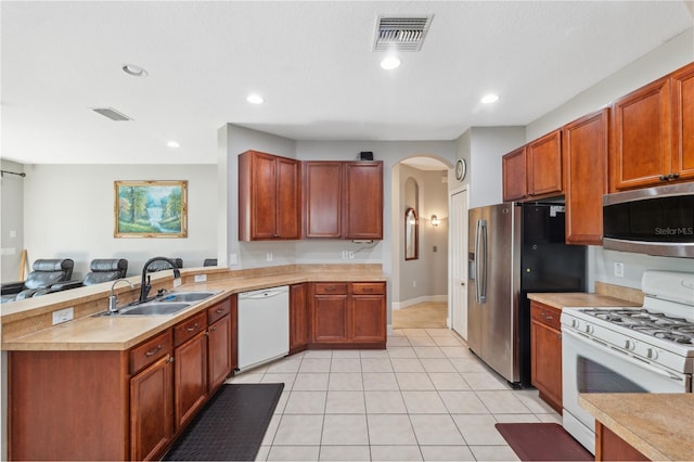 kitchen featuring light tile patterned floors, sink, and appliances with stainless steel finishes